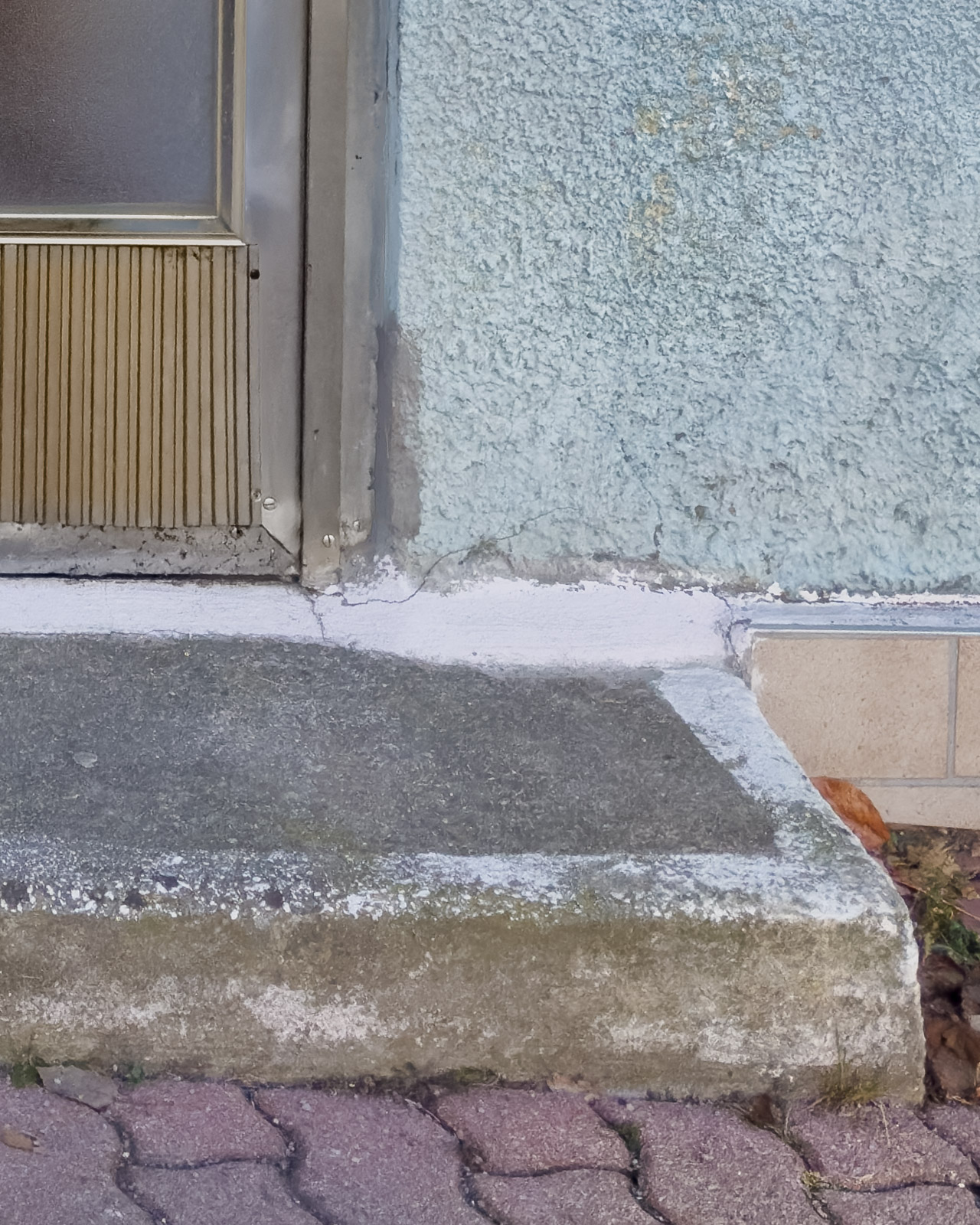 Concrete step and wall junction showing wear and repairs in Zeltweg.