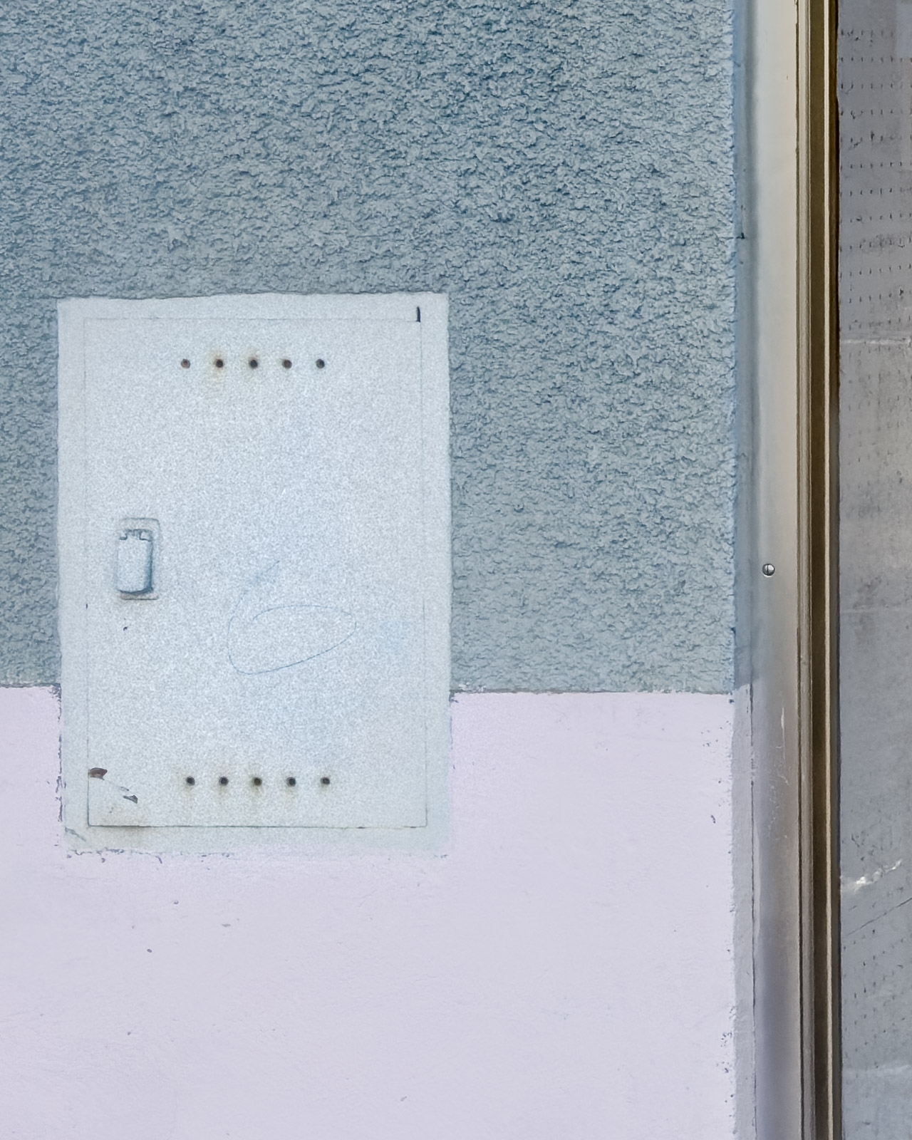 Electrical service box mounted on a weathered facade in Zeltweg, Austria.