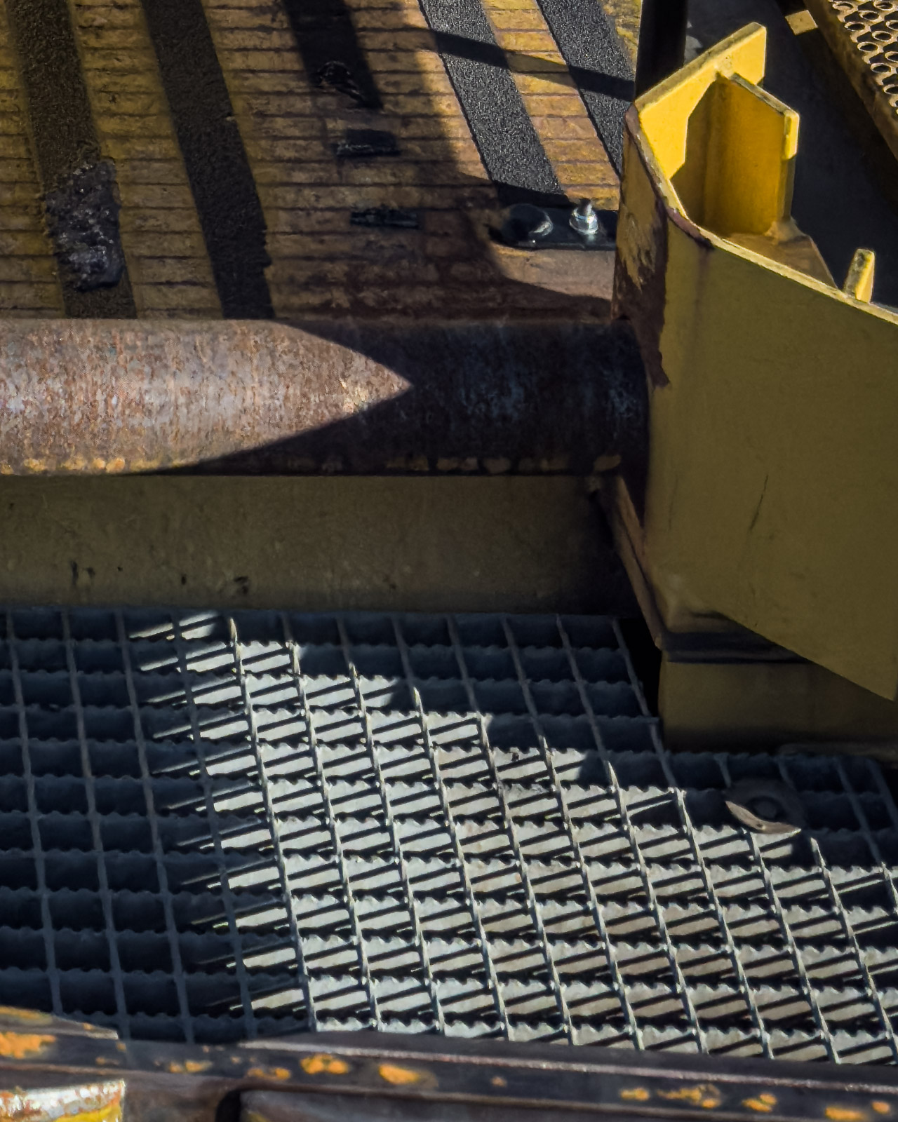Close-up of worn industrial machinery and metal grating in Zeltweg.